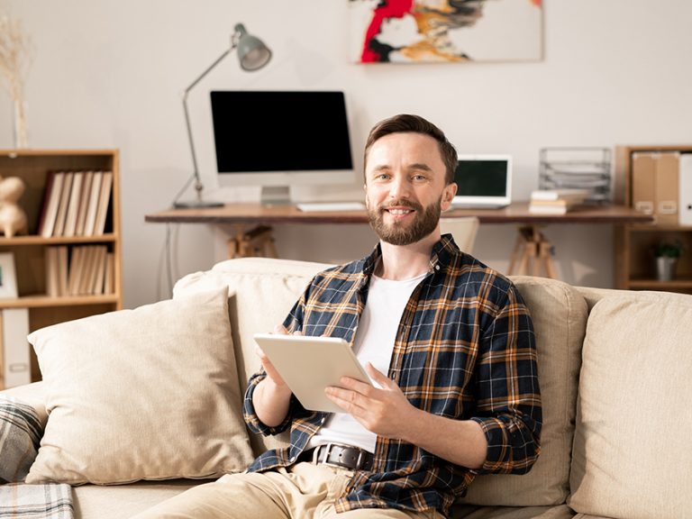 Photo of man in living room illustrates blog:"Did You Request an Extension to File Your 2020 taxes? The Deadline Is Almost Here!"