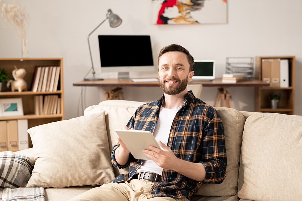 Photo of man in living room illustrates blog:"Did You Request an Extension to File Your 2020 taxes? The Deadline Is Almost Here!"