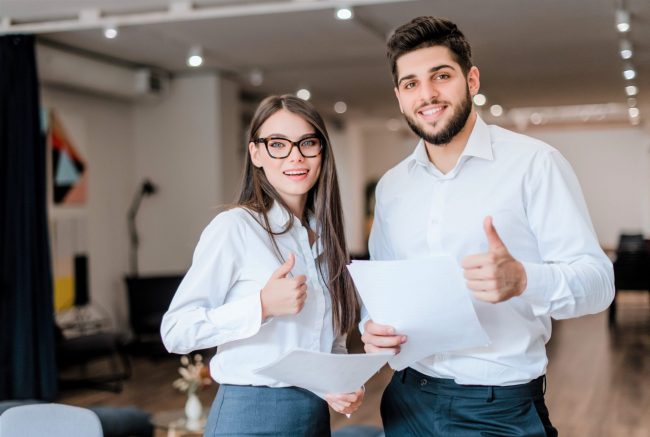 Image of confident businesswoman and businessman illustrates blog: "Who Needs Business Owners Policy (BOP) Insurance?