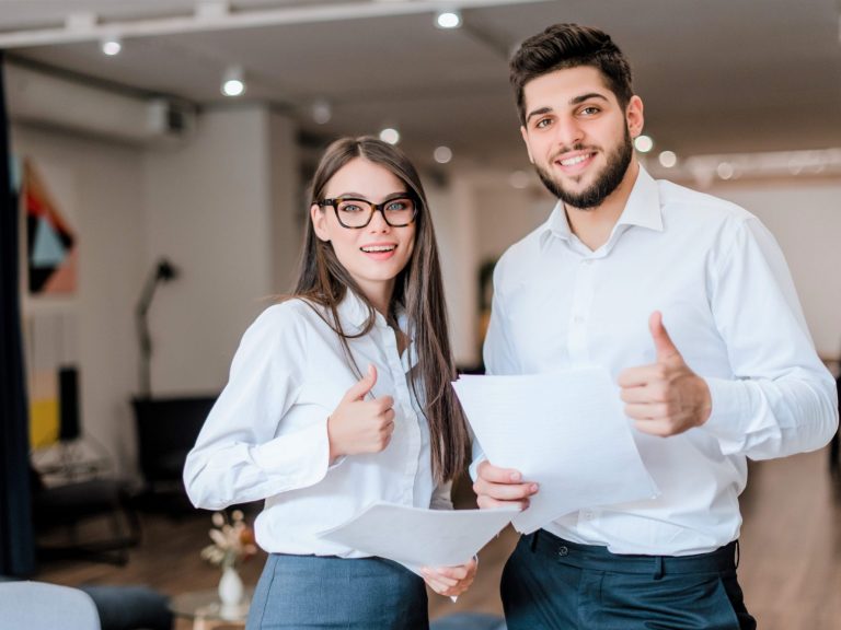 Image of confident businesswoman and businessman illustrates blog: "Who Needs Business Owners Policy (BOP) Insurance?