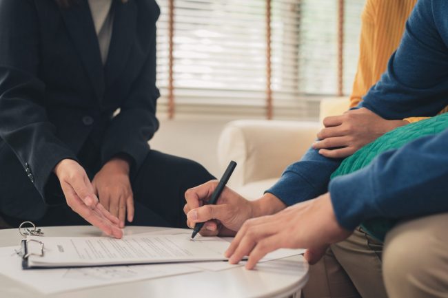 Image of couple signing document illustrates blog "3 good reasons to get Earthquake Insurance"