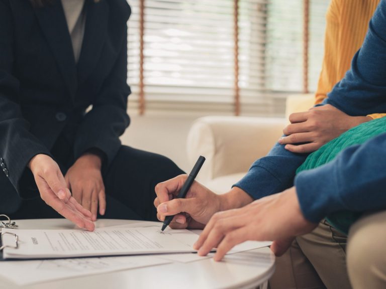 Image of couple signing document illustrates blog "3 good reasons to get Earthquake Insurance"