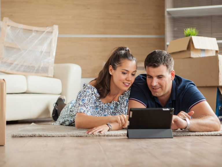 Photo of couple looking at laptop illustrates blog: "What is Condo Insurance?"