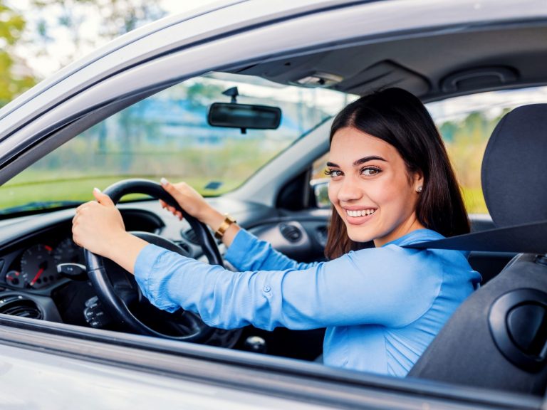 Photo of woman in car illustrates blog: "Like most states, California requires drivers to carry auto insurance. So this is an essential coverage if you live or plan to move to the Golden State. Keep reading to learn more about auto insurance in California, including some facts you probably didn’t know. "