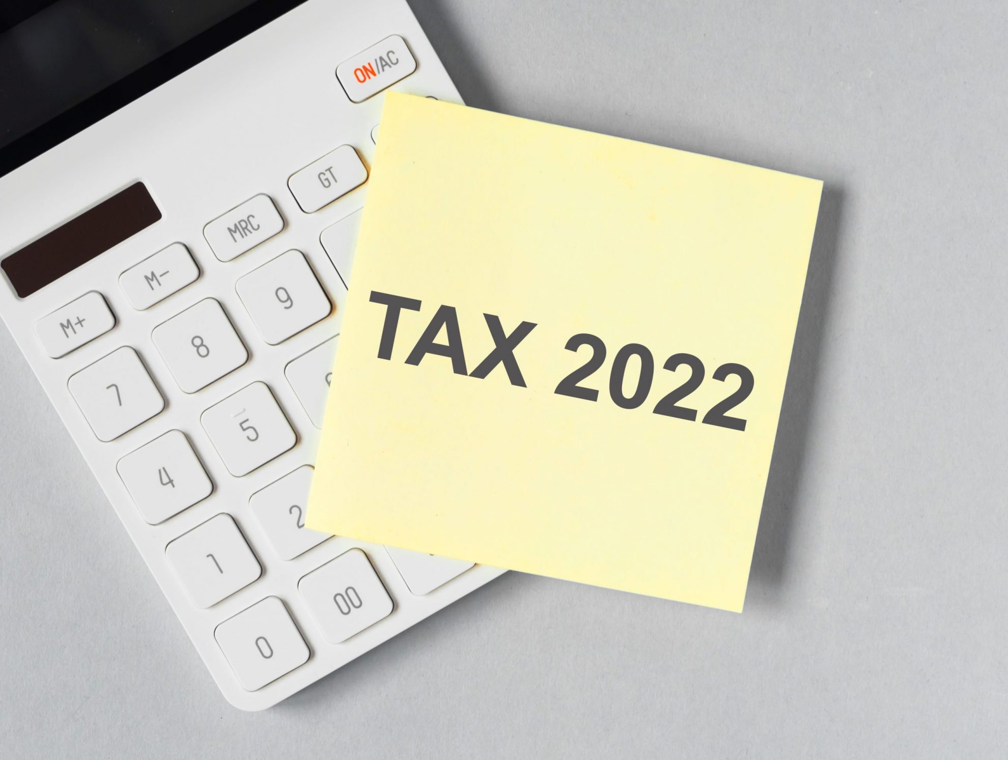 Photo of calculator with post-it: "When Is Tax Day in 2022?"