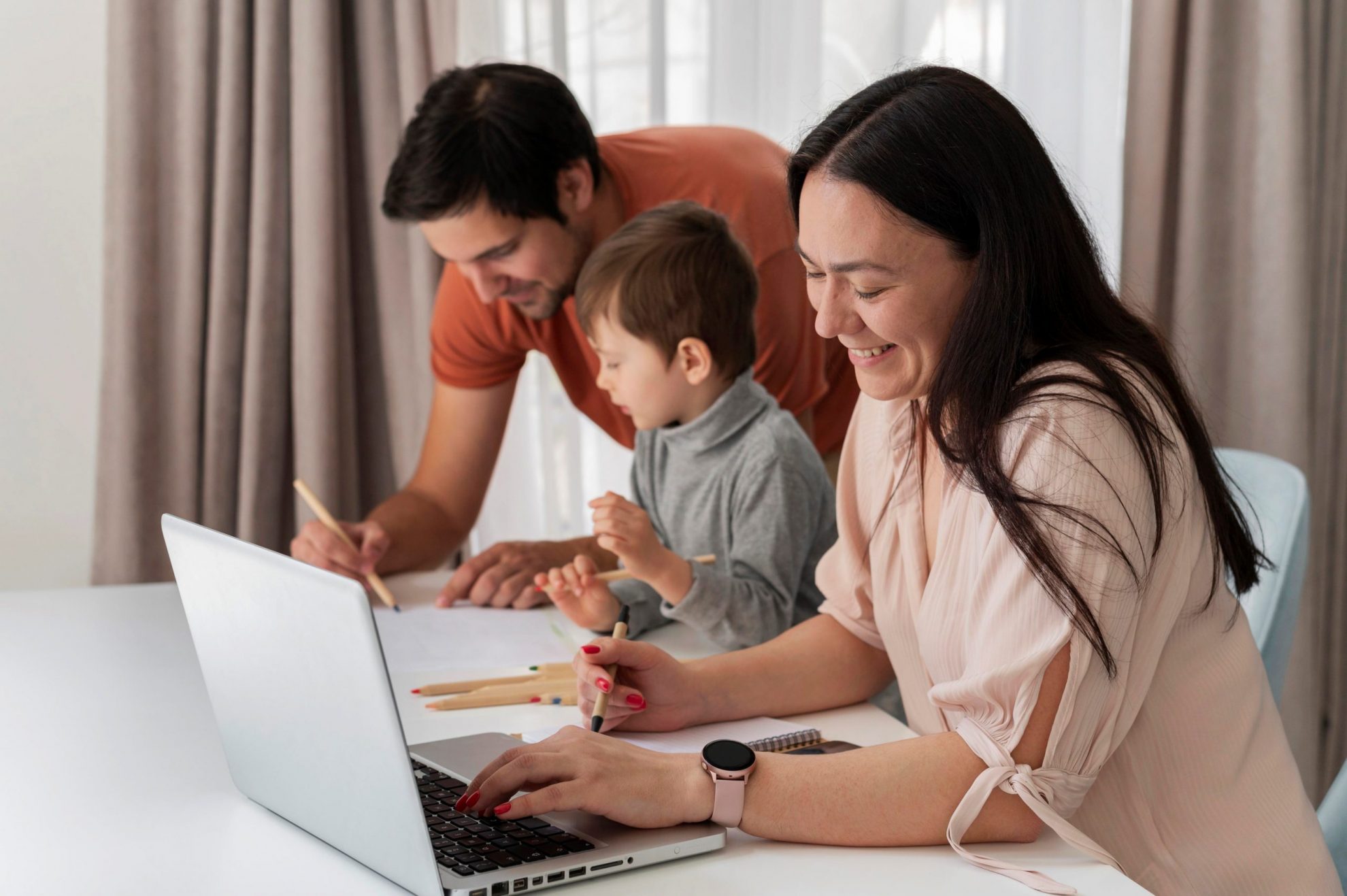 Photo of family in front of laptop illustrates blog: "Advance Child Tax Credit Payments and Your 2021 Tax Return"