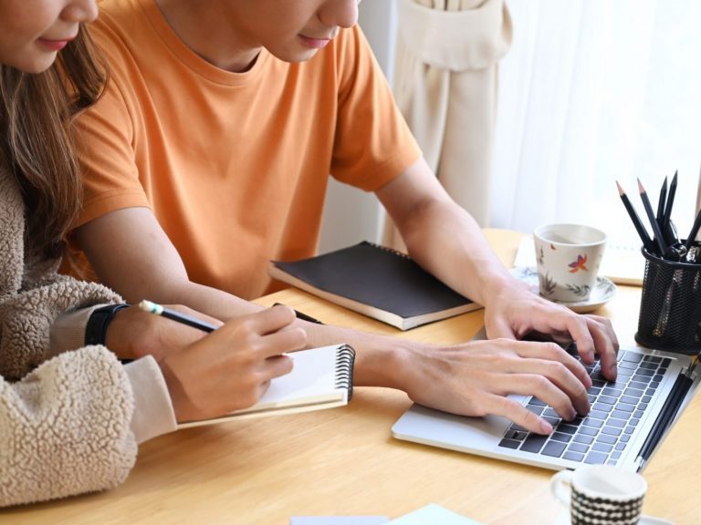 Photo of couple looking at laptop illustrates blog: "Essential Tips to Navigate the 2022 Tax Season"