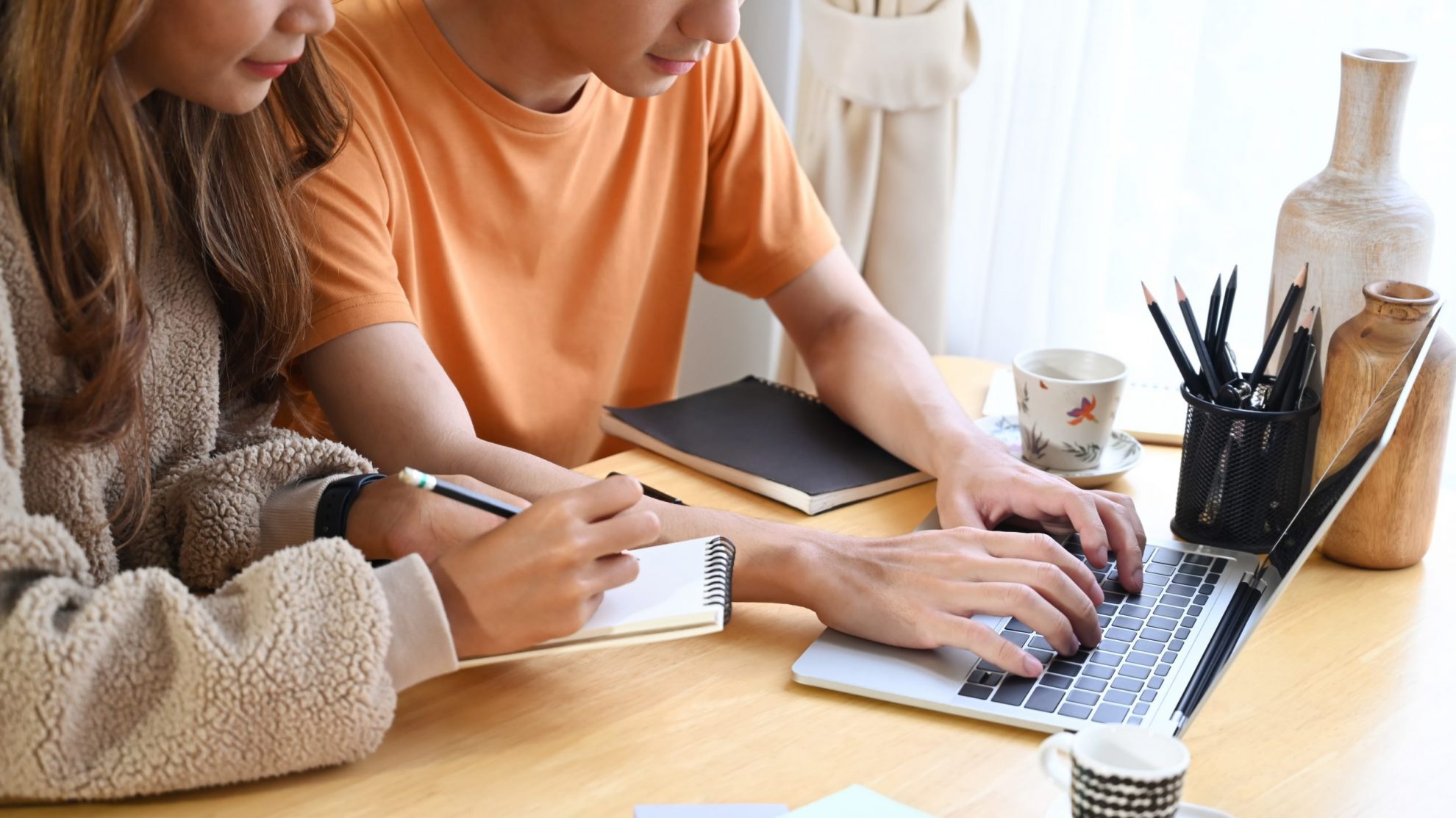 Photo of couple looking at laptop illustrates blog: "Essential Tips to Navigate the 2022 Tax Season"