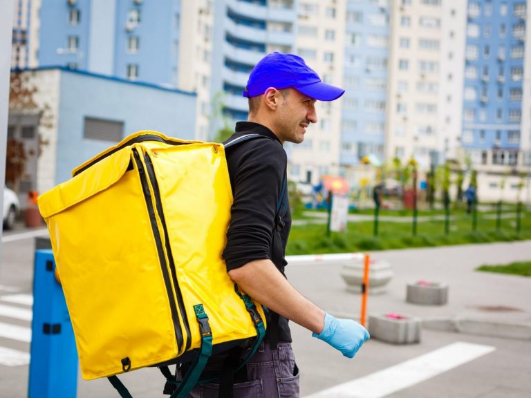 Photo of man with delivery backpack illustrates blog: "Tax Season Reminder: Gig Economy Income Is Taxable"