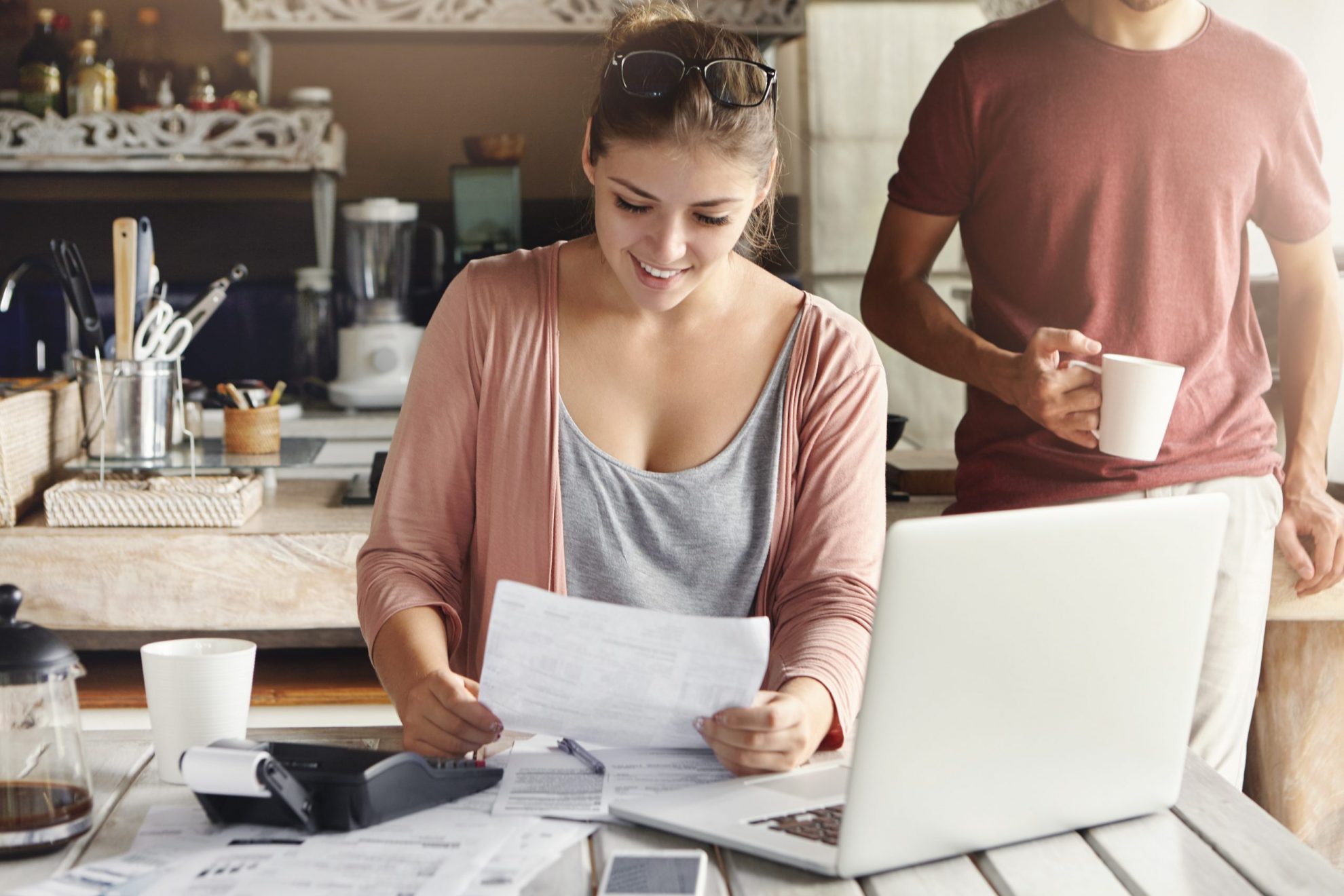 Photo of smiling couple in kitchen illustrates blog: "Tax Day 2022: What You Need to Know"