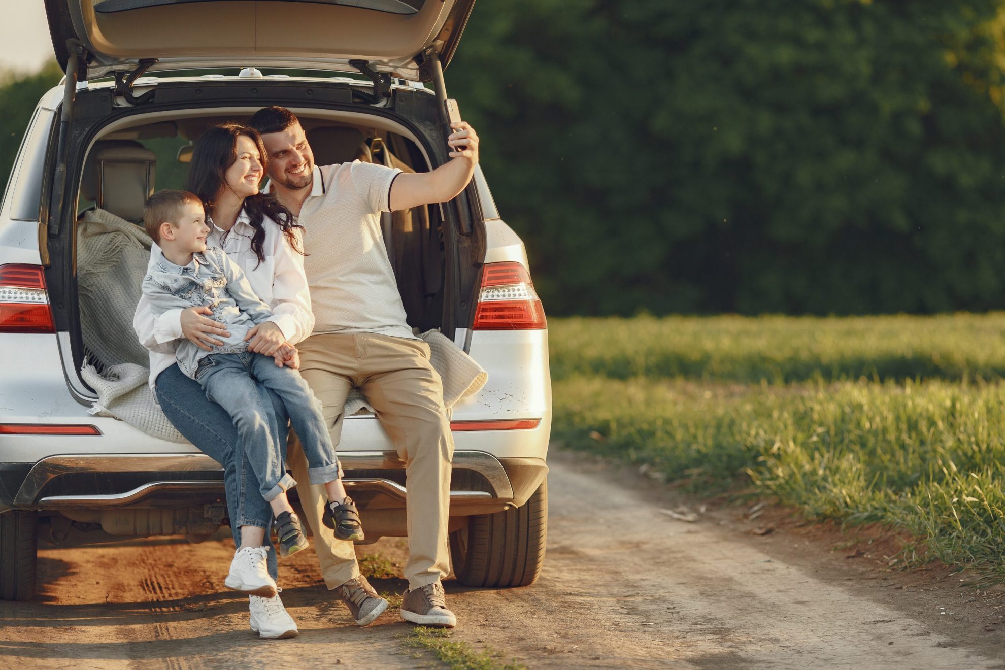 Photo of family posing for selfie in the back of a SUV illustrates blog: "Full Coverage Auto Insurance in California: What You Need to Know"