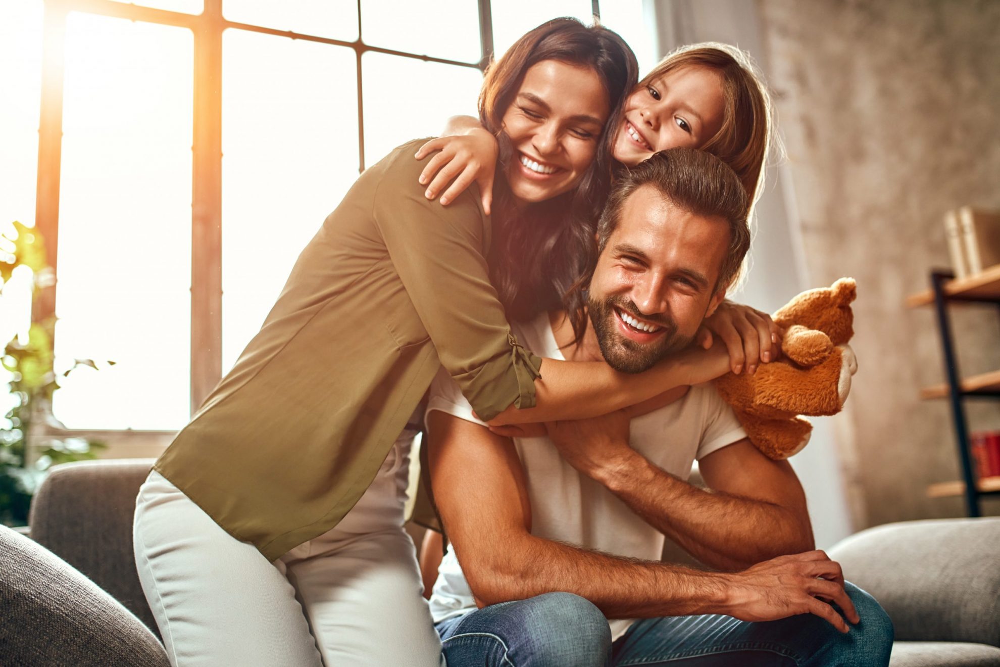 Photo of happy family illustrates blog "7 Factors That Impact Your Home Insurance Rates"