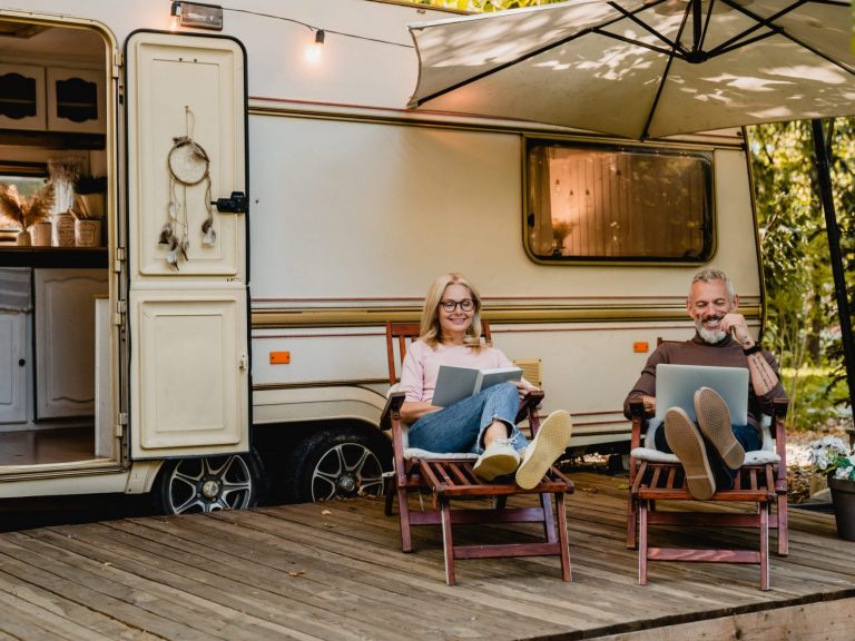 Couple in front of RV illustrates blog: "Does RV Insurance Cover Mold?"