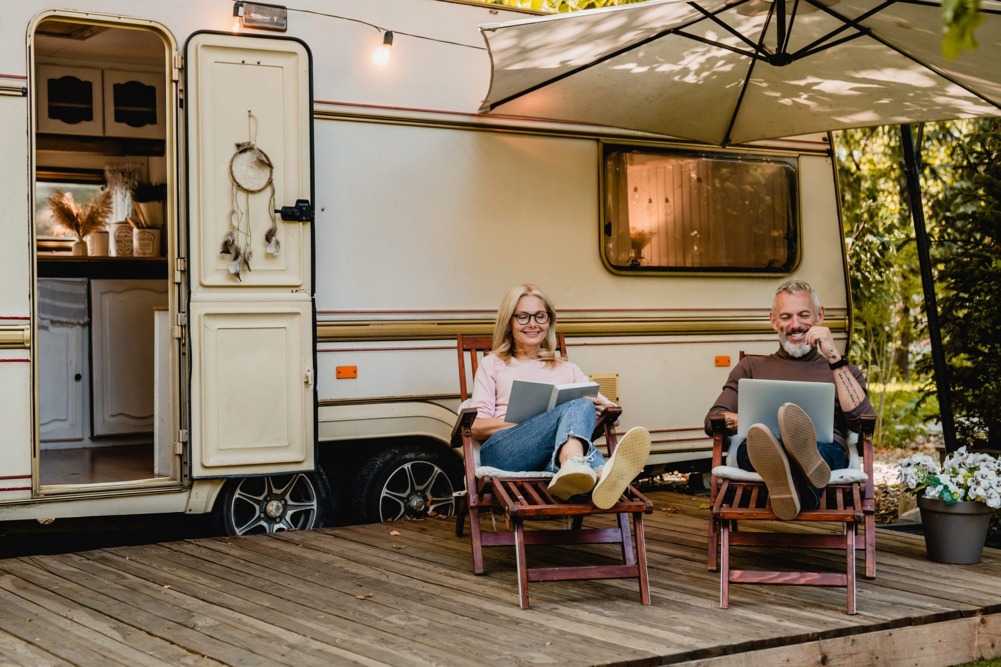 Couple in front of RV illustrates blog: "Does RV Insurance Cover Mold?"