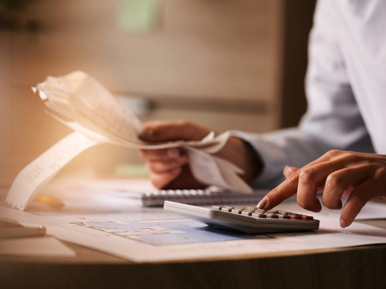 Close-up of person using calculator illustrates blog "California Extends Tax Deadline for California Storm Victims"
