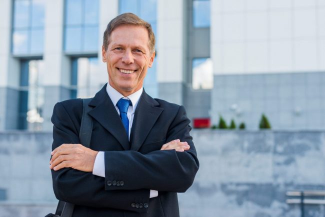 Busiinessman Smiling businessman illustrates blog "Commercial insurance: What You Need To Know"