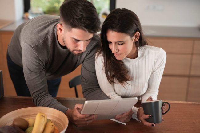 couple-FP Couple looking at receipts illustrates blog "5 Ideas for Keeping Good Tax Records"