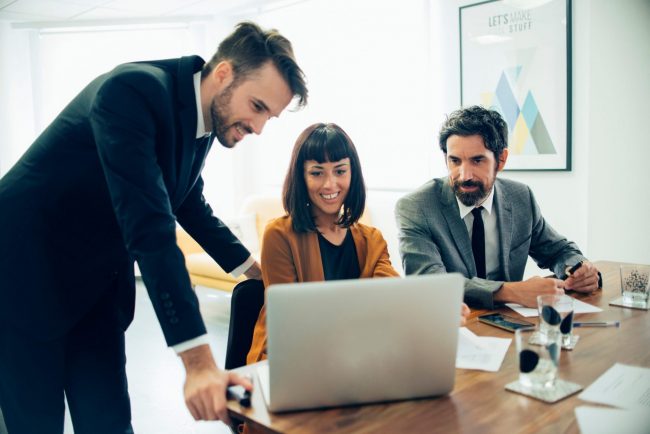 LLC-FP Two men and one woman in business attire illustrate blog "What Is an LLC?"