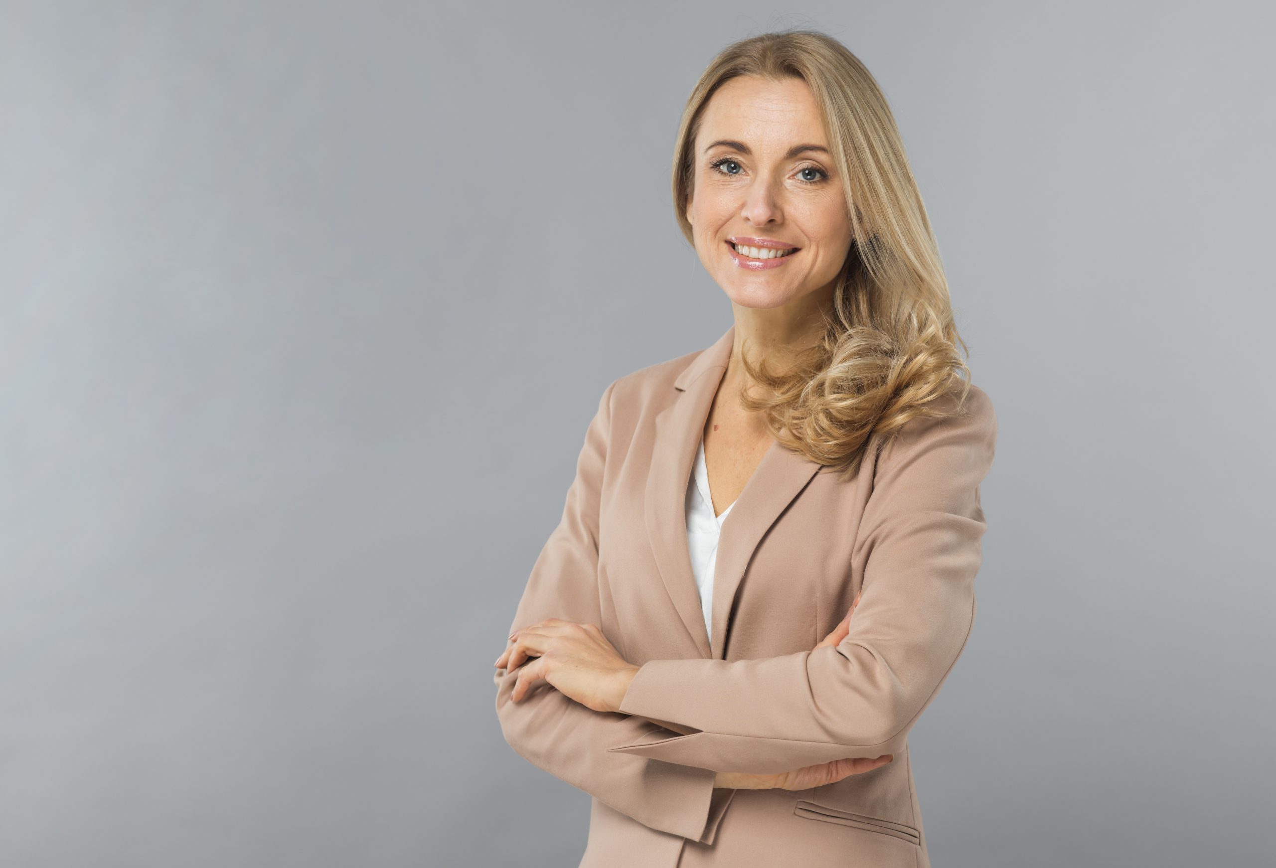 Smiling businesswoman illustrates blog "How Much Insurance Does My Business Need? "