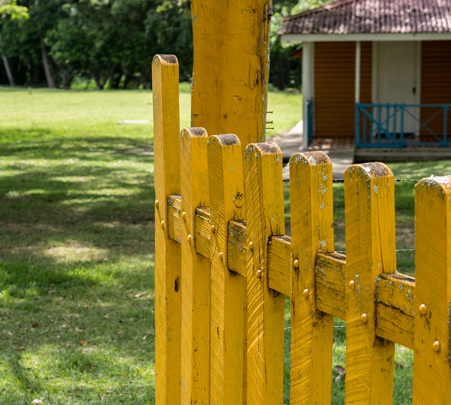 Birán, Cuba – September 1, 2017: A yellow painted fence on the