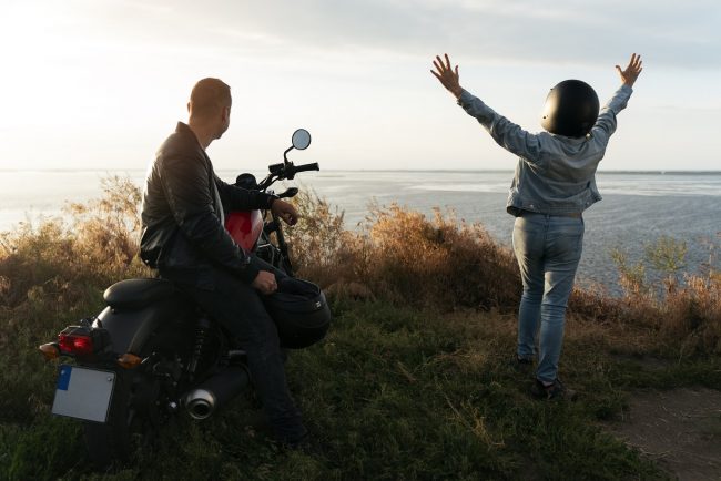motorbike-two-people-freepik Man and woman with motorbike.