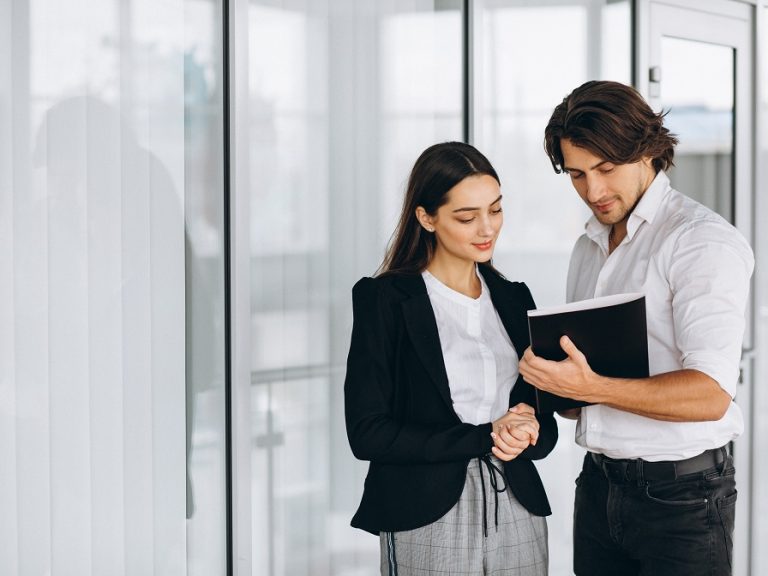 Two collegues working in a business center Businesspeople illustrate blog "10 Business Insurance Terms You Need to Know"
