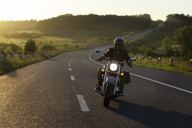 motorcycle-insurance-freepik Person rinding motorbike in country road illustrates blog "Motorcycle Insurance for Beginners: Avoiding Common Pitfalls"