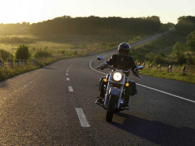 motorcycle-insurance-freepik Person rinding motorbike in country road illustrates blog "Motorcycle Insurance for Beginners: Avoiding Common Pitfalls"