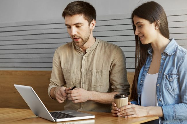 Man and woman looking at laptop illustrate blog "What Is a Tax Credit?"
