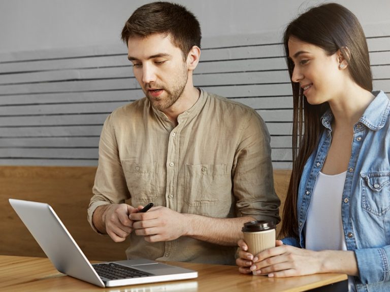 Man and woman looking at laptop illustrate blog "What Is a Tax Credit?"