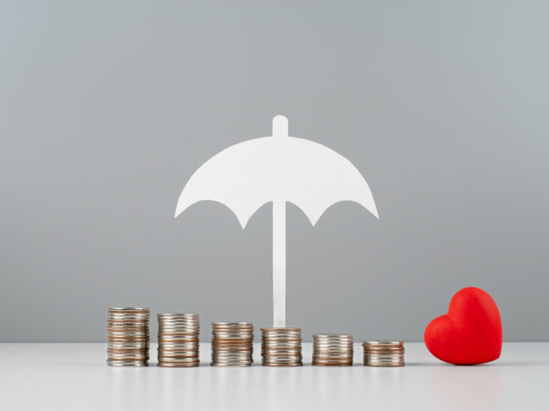 2149191400 Stacked coins with umbrella and heart symbolizing bundle home and auto insurance protection