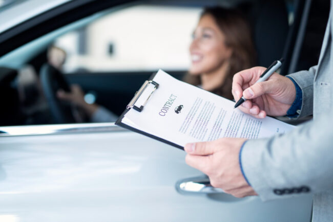 748 Person signing rental car agreement with temporary auto insurance coverage"
